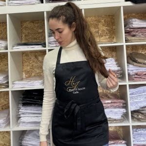 Avental de cabeleireiro profissional preto modelo Paris resistente a descolorante com bolsos e fitas ajustáveis